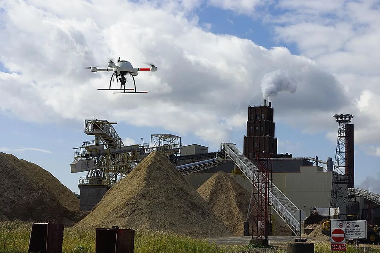 A survey drone flying over material stockpiles at an industrial site