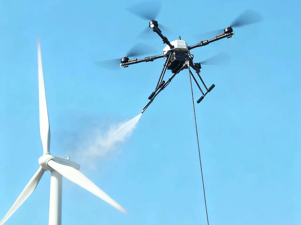 A drone cleaning a wind turbine blade